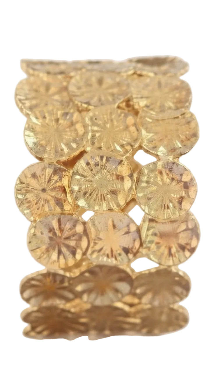 Brazalete de lentejuelas doradas sostenido en la mano