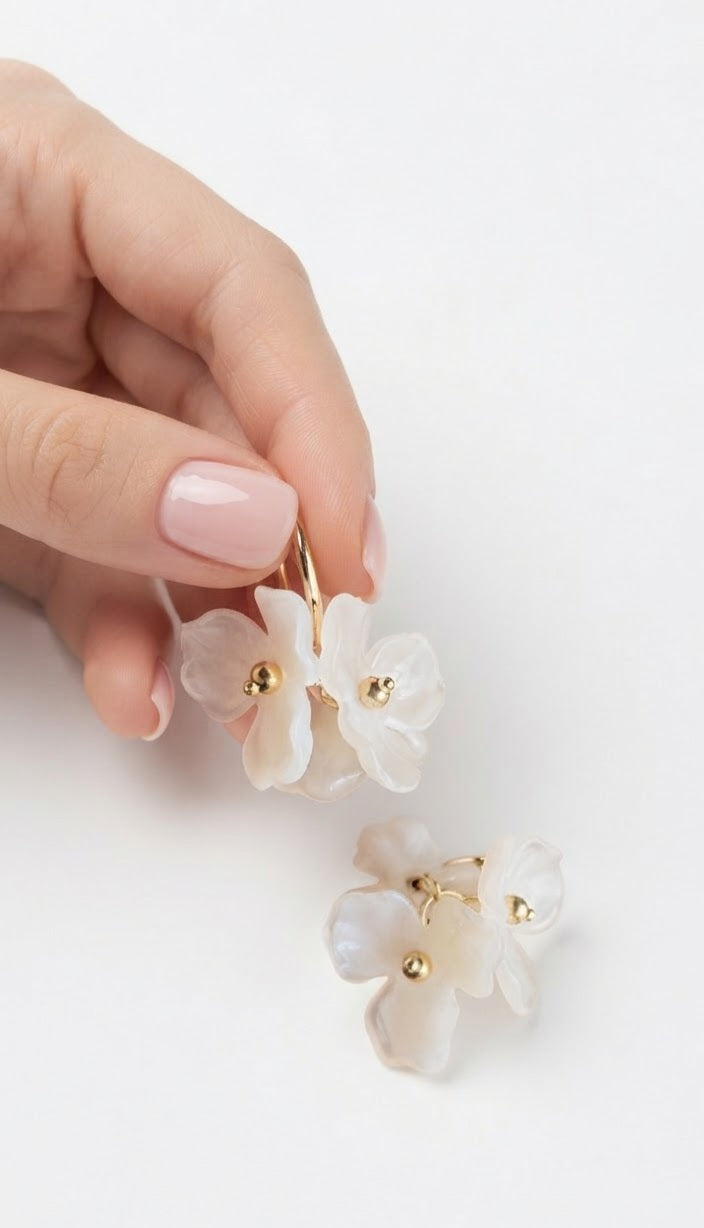 Pendientes aro dorado flor blanca acrílica en mano par