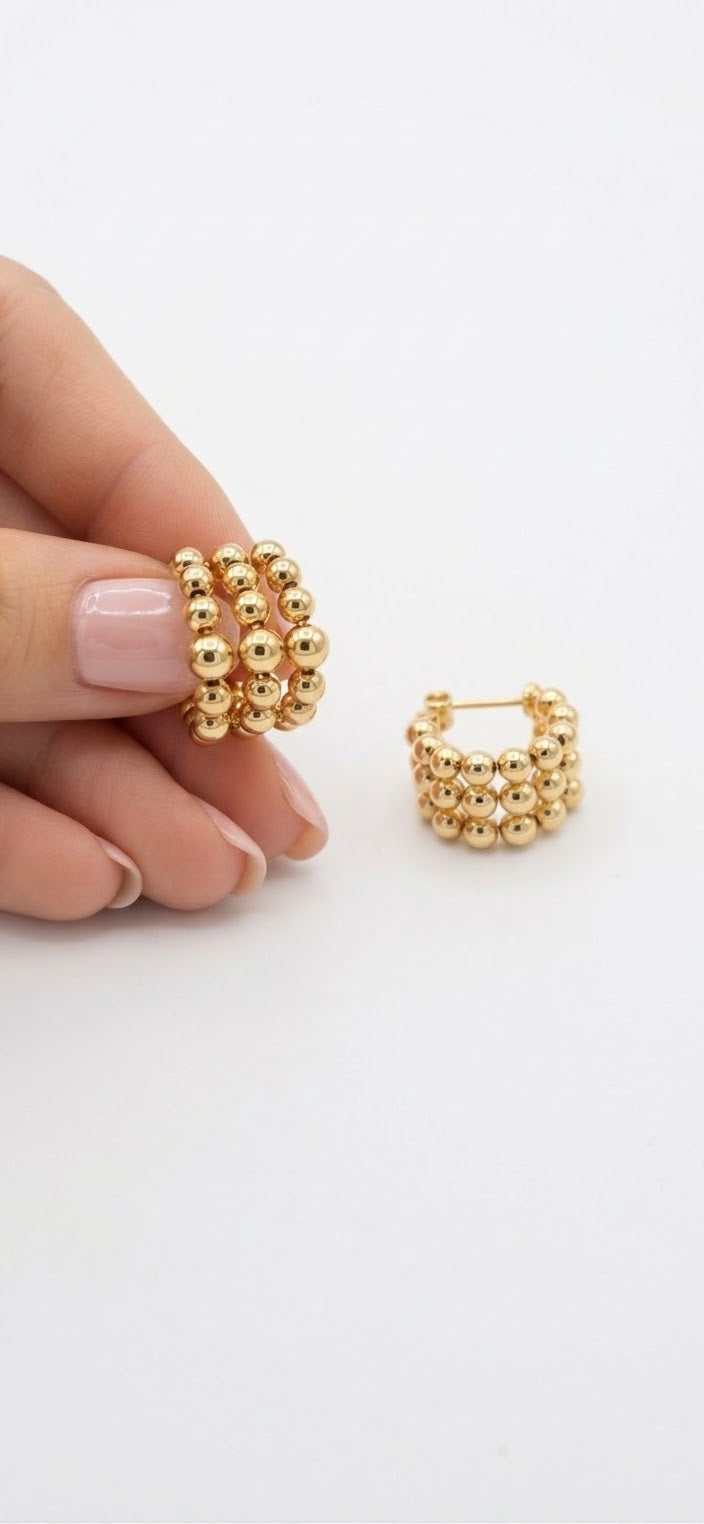 Aros bolas acero dorado en mano par