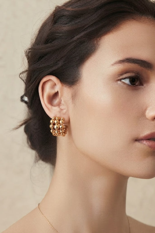 Aros bolas acero dorado puestos modelo